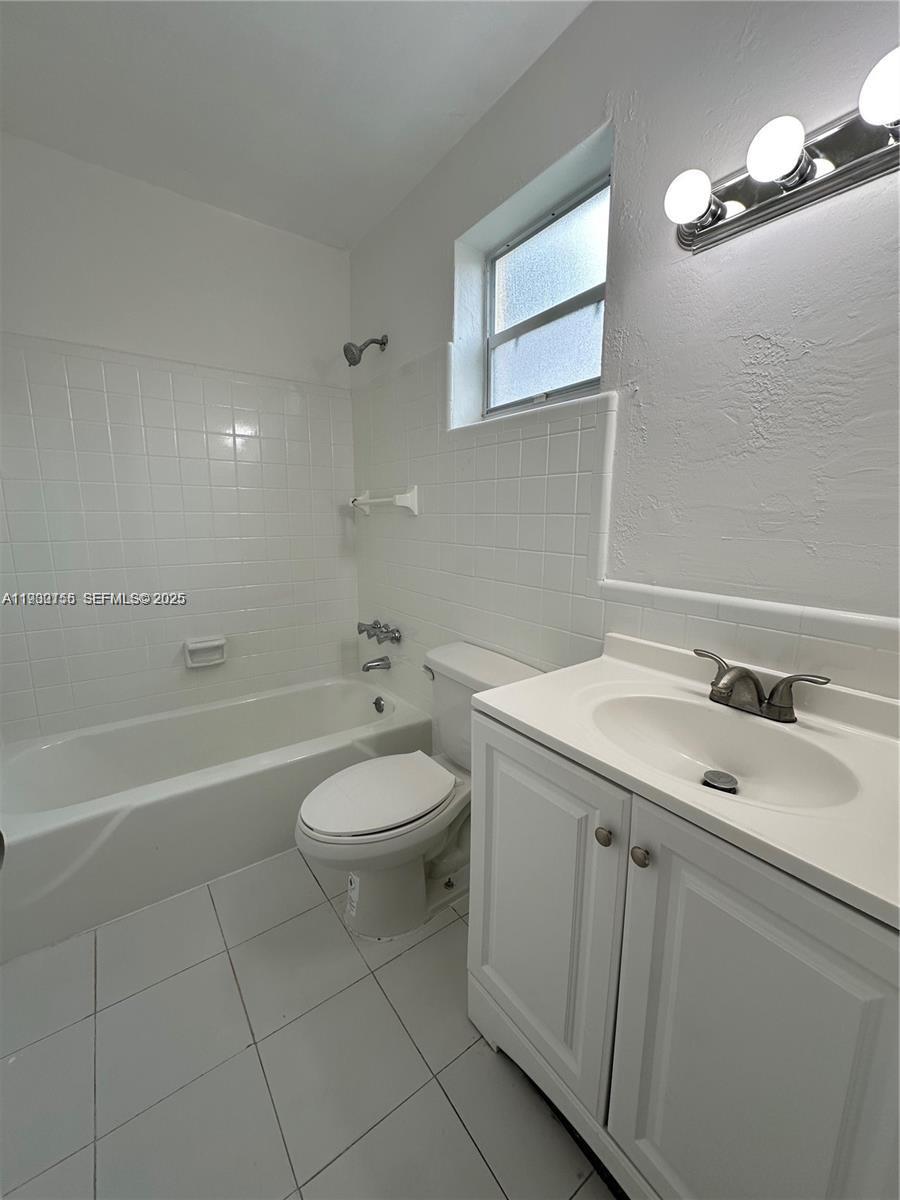 1733 Mayo Street, Unit 2 Hollywood, FL 33020 - Photo 5 of 10 a bathroom with a sink a toilet and bathtub