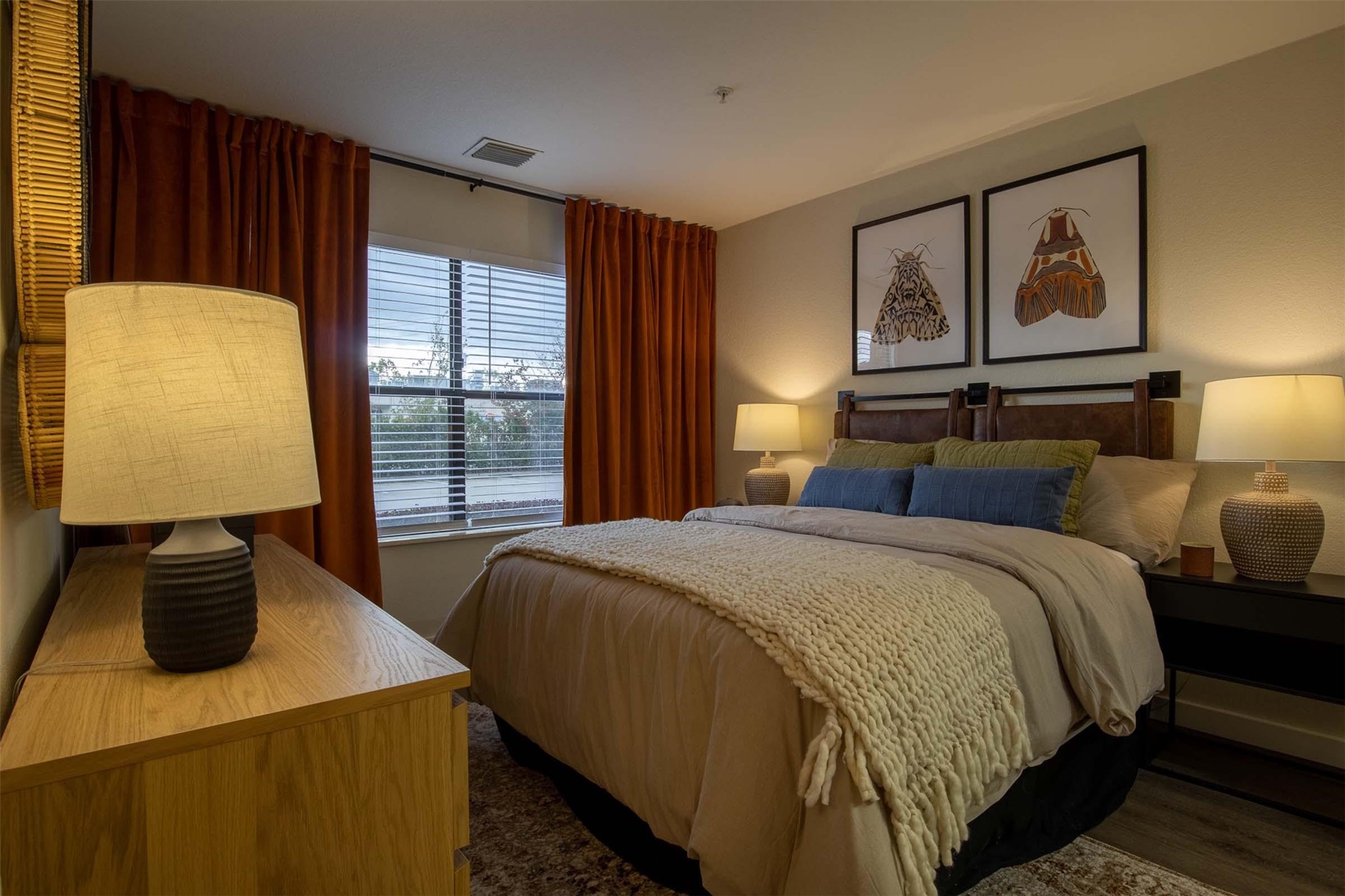 18828 Highway 249, Unit 124 Houston, TX 77070 - Photo 11 of 49 a bedroom with a bed and dresser with mirror