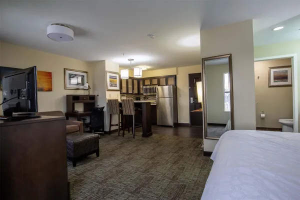 a bedroom with furniture and a flat screen tv