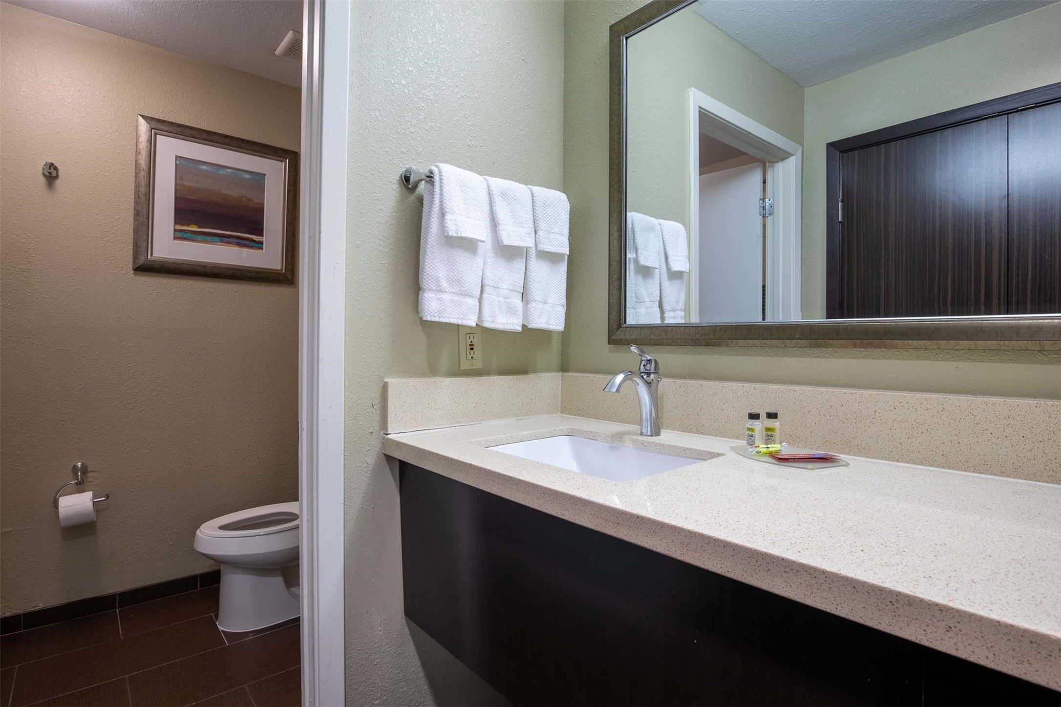 18828 Highway 249, Unit 124 Houston, TX 77070 - Photo 28 of 49 a bathroom with a sink a toilet and a large mirror