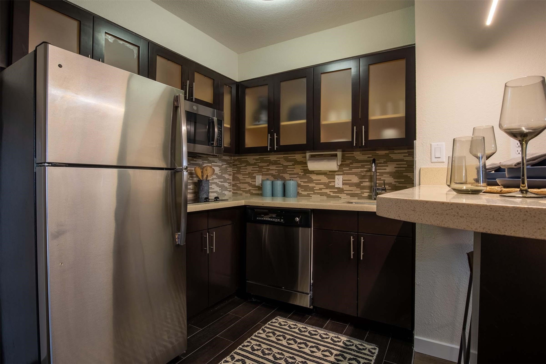 18828 Highway 249, Unit 124 Houston, TX 77070 - Photo 3 of 49 a kitchen with refrigerator a sink and cabinets