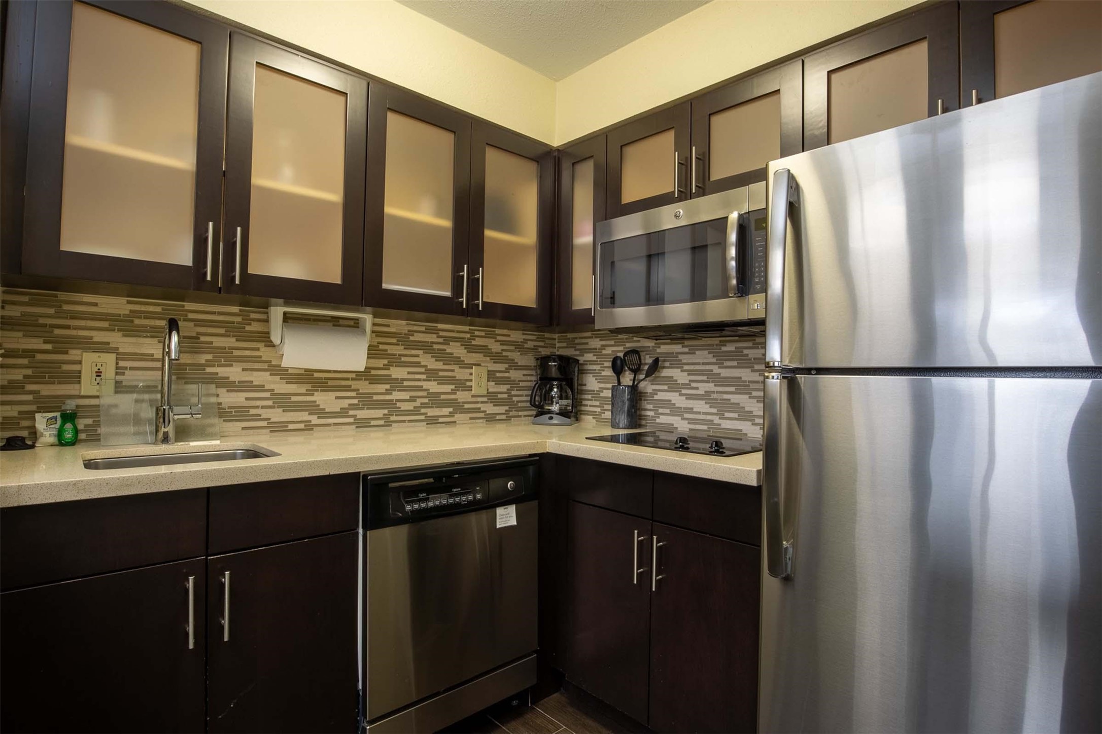 18828 Highway 249, Unit 124 Houston, TX 77070 - Photo 41 of 49 a kitchen with stainless steel appliances granite countertop a sink and a refrigerator