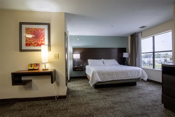 a bedroom with a bed and window