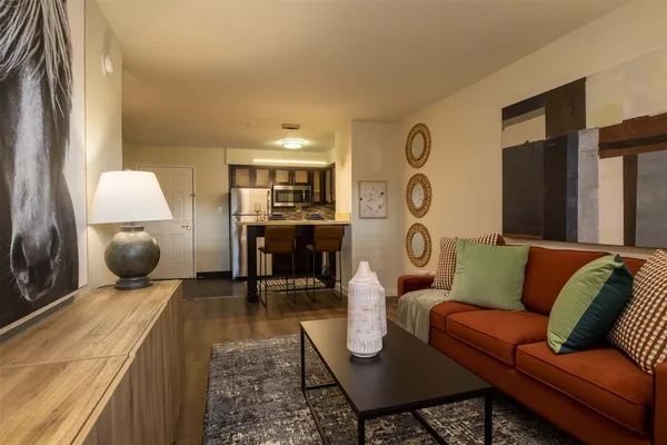 a living room with furniture and wooden floor