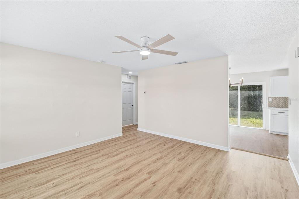 4320 Carousel Road Orlando, FL 32808 - Photo 2 of 18 an empty room with wooden floor and windows