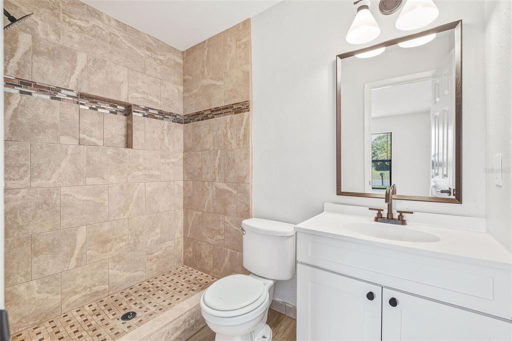 4320 Carousel Road Orlando, FL 32808 - Photo 9 of 18 a bathroom with a sink toilet and shower