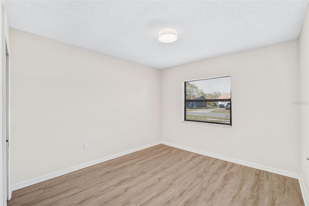 4320 Carousel Road Orlando, FL 32808 - Photo 10 of 18 a view of a small space with wooden floor and a window