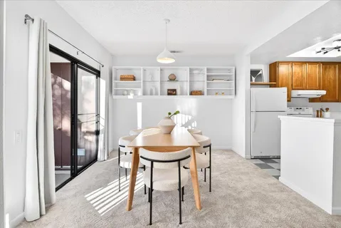 a dining room with furniture and window