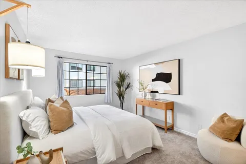 a bedroom with a bed and window