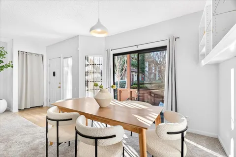 a dining room with furniture and window