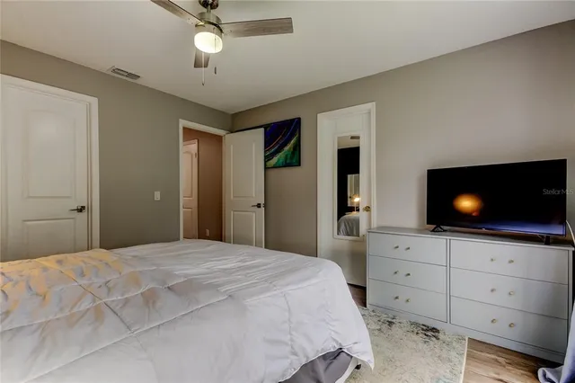 a bedroom with a bed and a flat screen tv