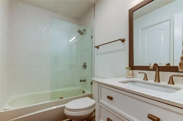 a bathroom with a sink a toilet and a bathtub