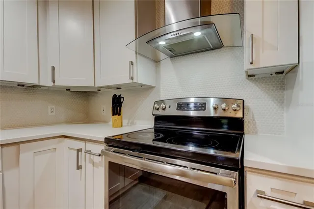 a view of a kitchen with closet and electronic appliances