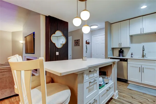 a dining room with furniture a chandelier and wooden floor