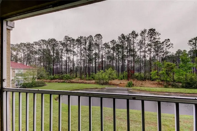 a front view of a house with porch and yard