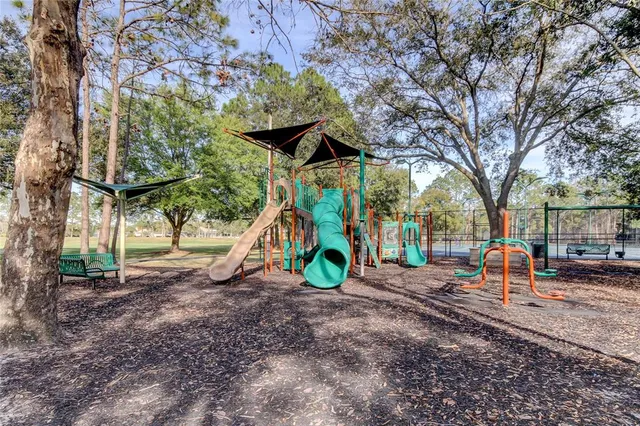 a view of a park with large trees