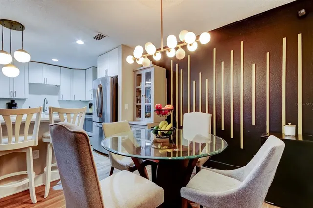 a view of a dining room with furniture and chandelier