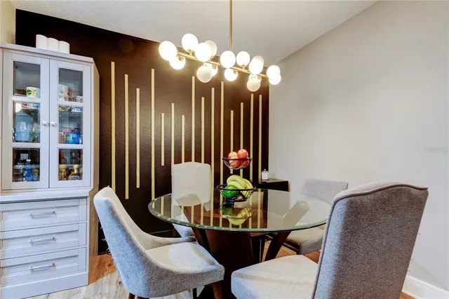 a view of a dining room with furniture and chandelier