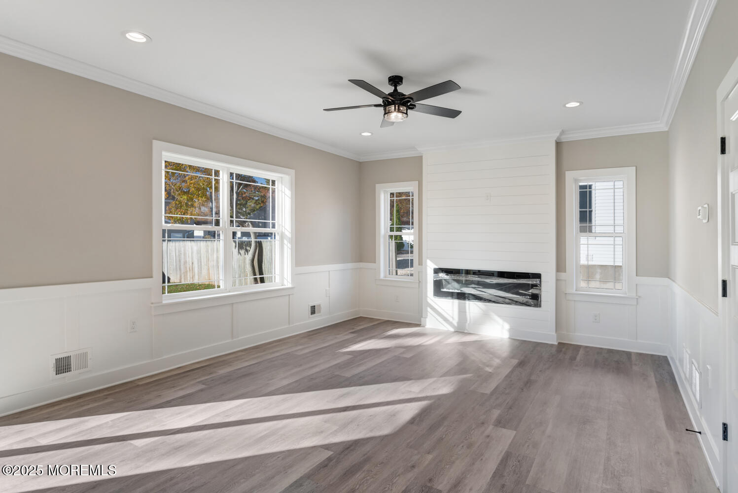 181 Bowline Road Manahawkin, NJ 08050 - Photo 8 of 17 a view of empty room with wooden floor and fan