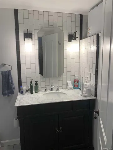 a bathroom with a double vanity sink and a mirror