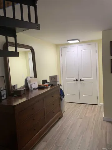 a room with two mirror and a wooden floors