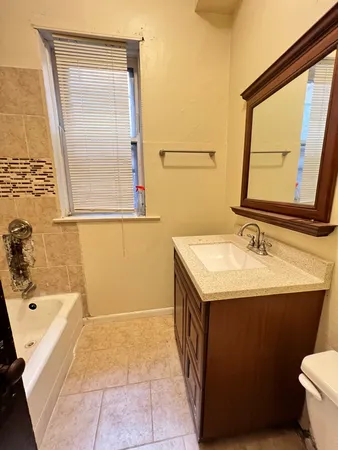 a bathroom with a sink a mirror and a bathtub