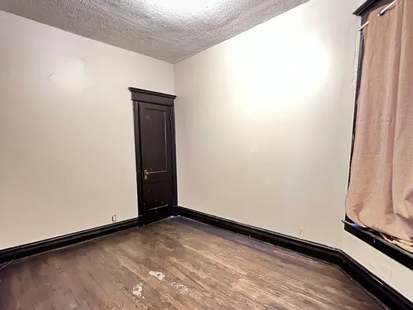 a bedroom with a bed and a mirror on the dresser