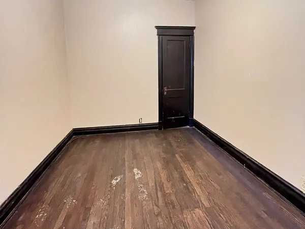 a bedroom with a bed and a potted plant