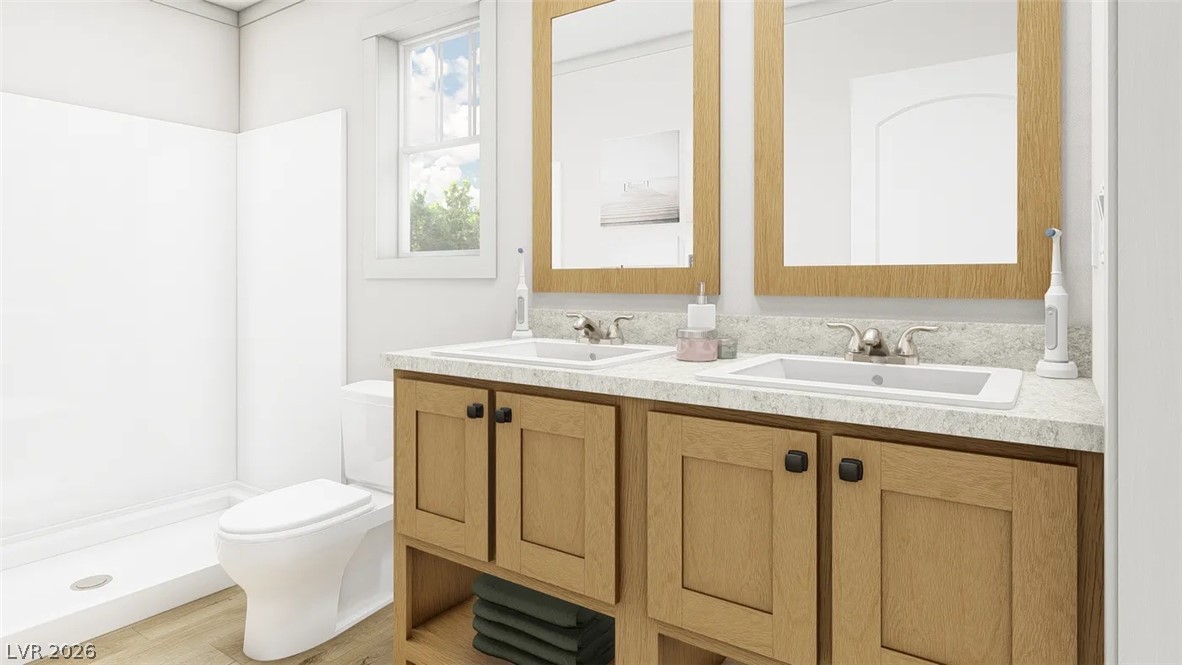 460 Box Canyon Road Alamo, NV 89001 - Photo 2 of 8 Double vanities with natural wood cabinetry flank a modern walk-in shower in this bright bathroom.