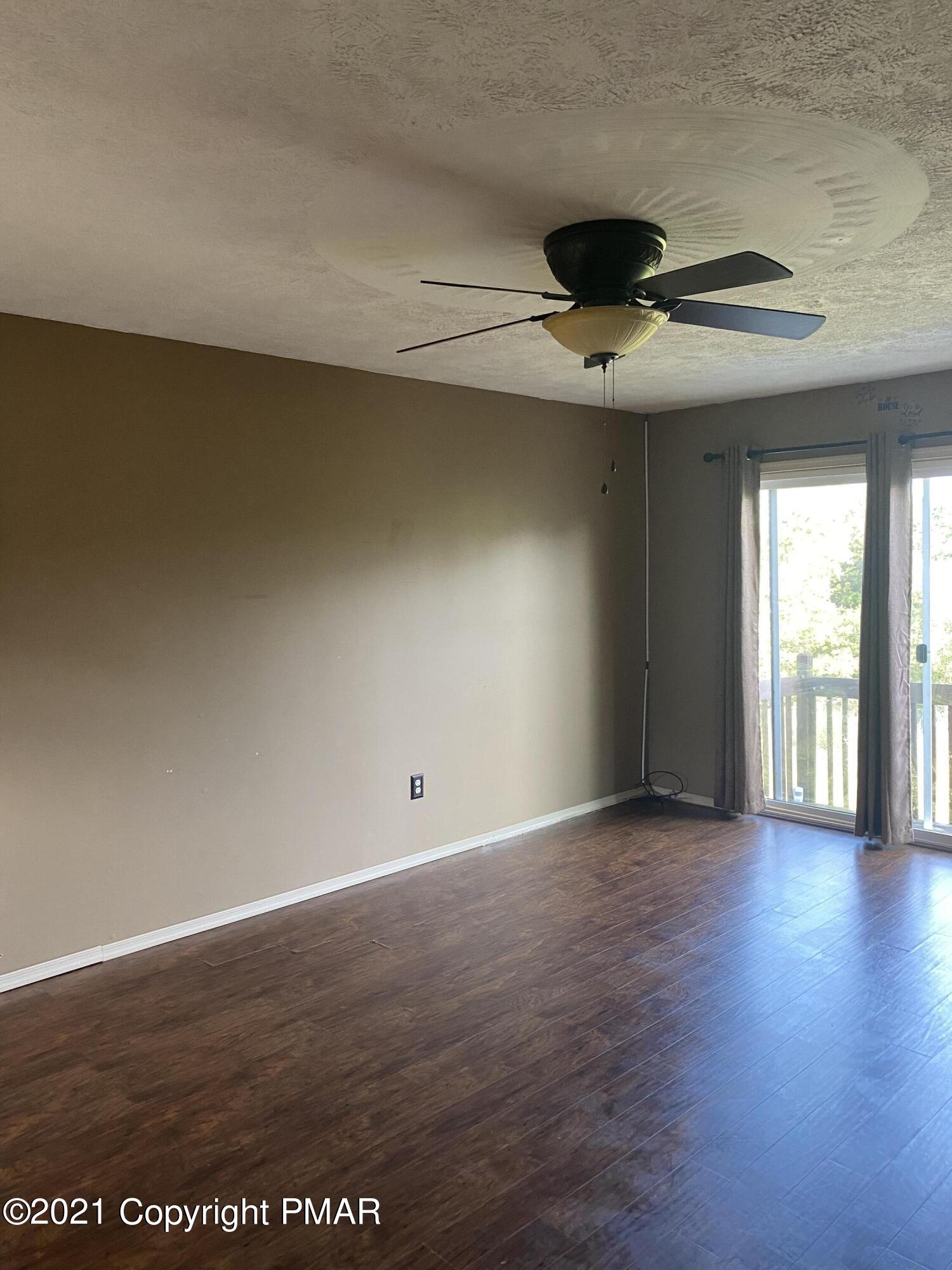 194 Ryan Road Blakeslee, PA 18610 - Photo 23 of 43 an empty room with wooden floor and windows