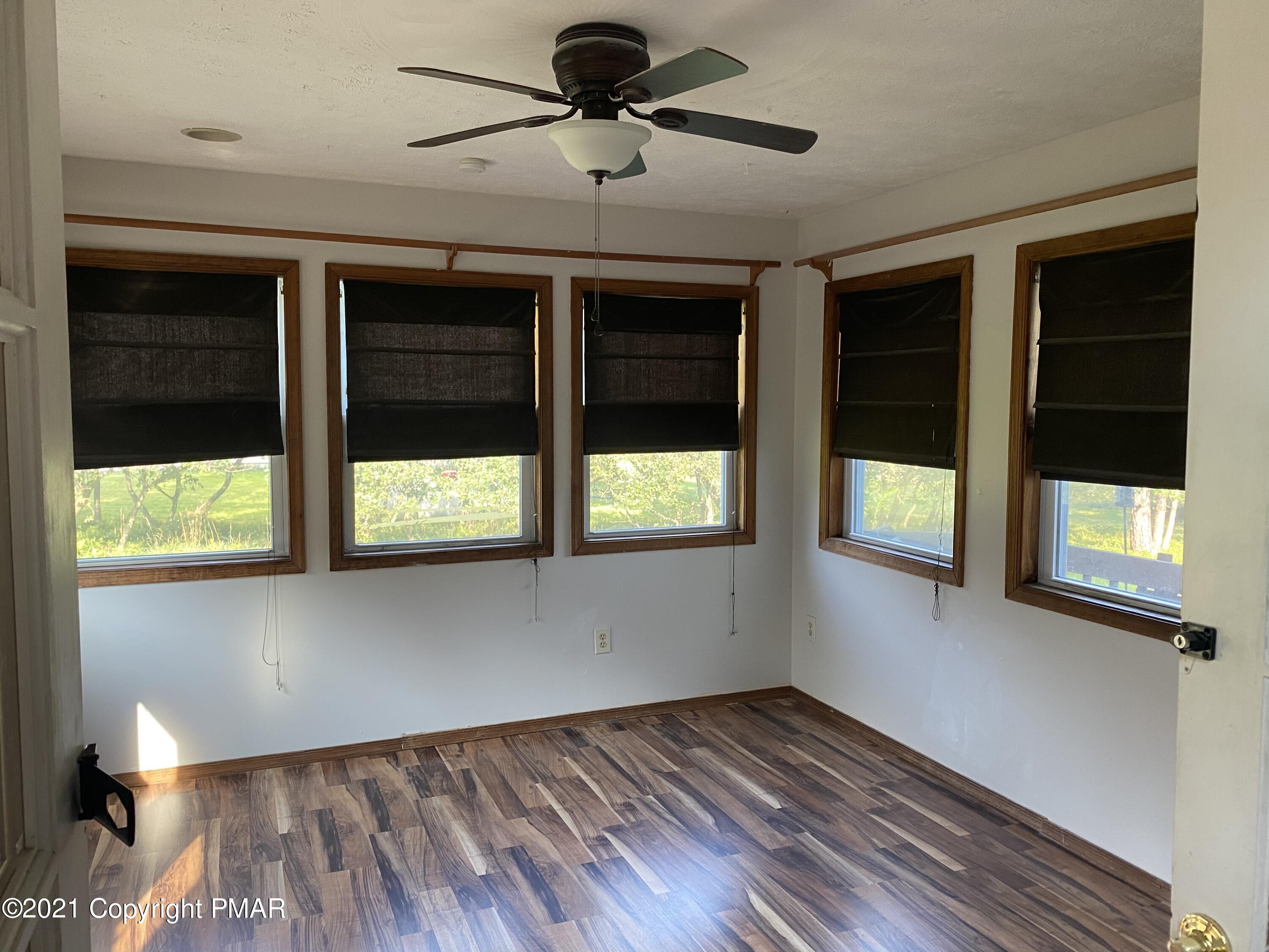 194 Ryan Road Blakeslee, PA 18610 - Photo 40 of 43 a view of an empty room with a window and wooden floor