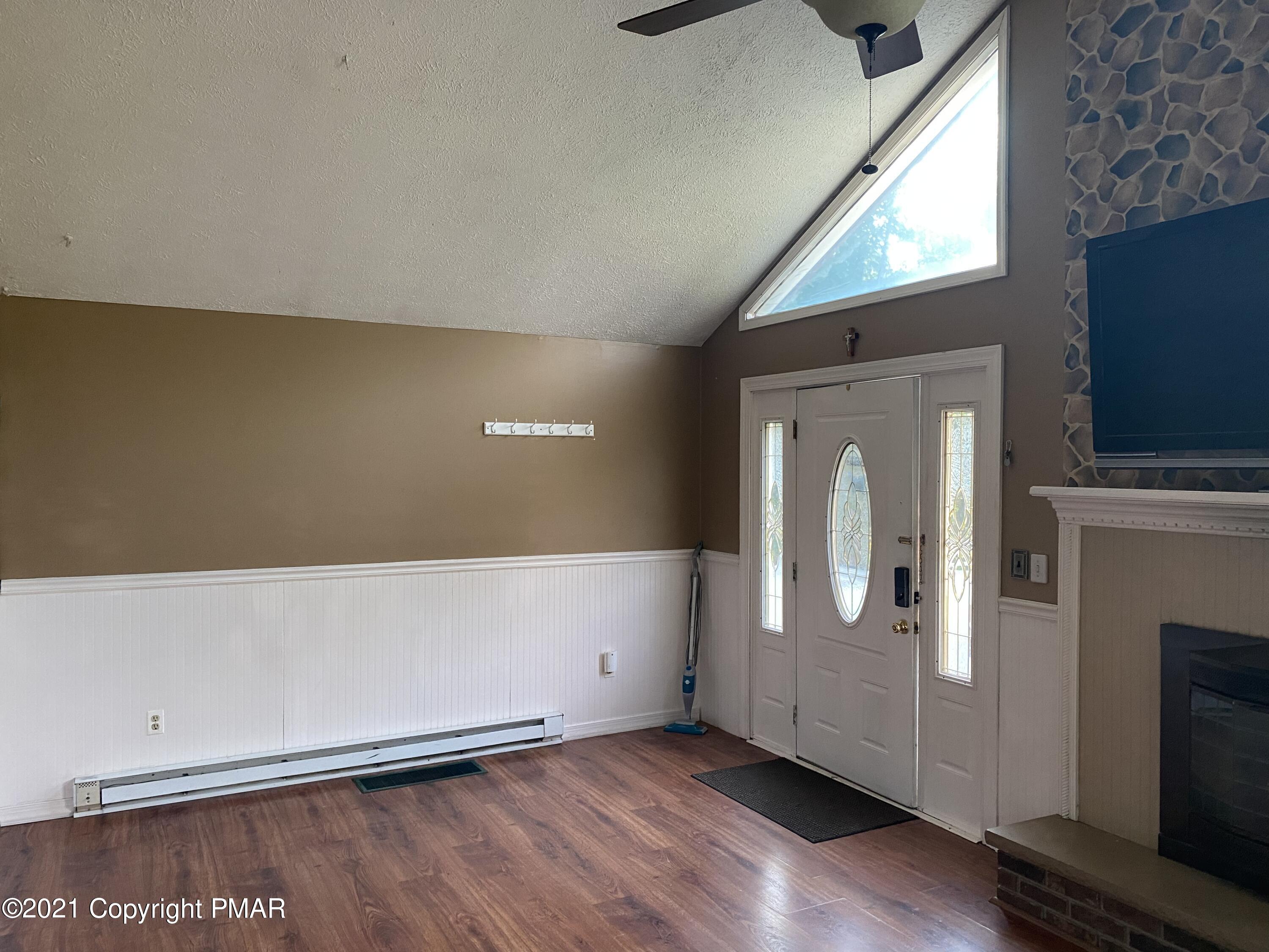 194 Ryan Road Blakeslee, PA 18610 - Photo 42 of 43 a view of an empty room with wooden floor and a window