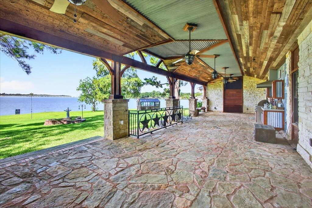 6903 Scott Street Eustace, TX 75124 - Photo 13 of 32 a view of a backyard with table and chairs under an umbrella