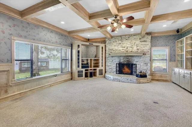 a view of an empty room with a fireplace and a large window