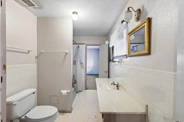 a bathroom with a toilet sink and shower