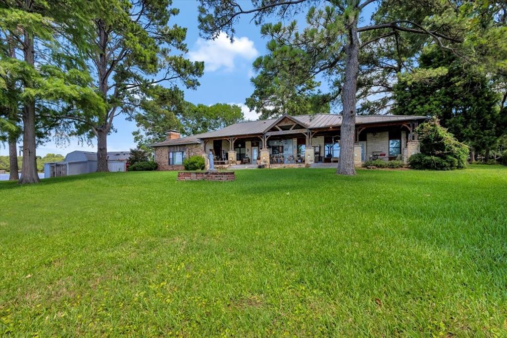 6903 Scott Street Eustace, TX 75124 - Photo 4 of 32 a view of a house with a big yard and large trees