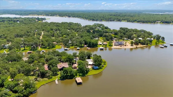 an aerial view of a houses with outdoor space and lake view