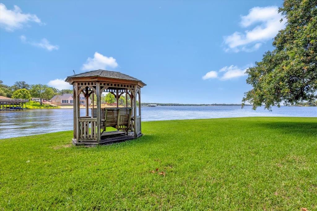 6903 Scott Street Eustace, TX 75124 - Photo 7 of 32 a view of a garden with a bench in the garden