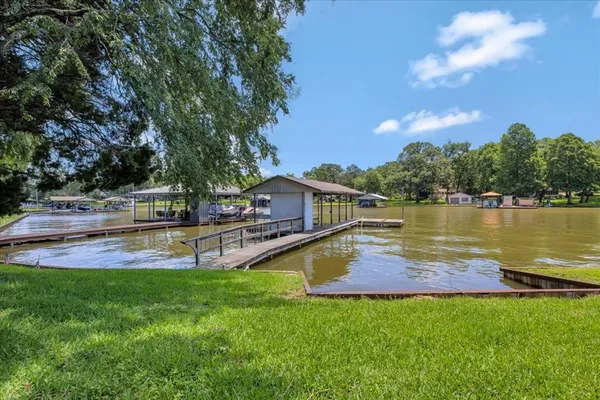 a view of a house with a yard and swimming pool
