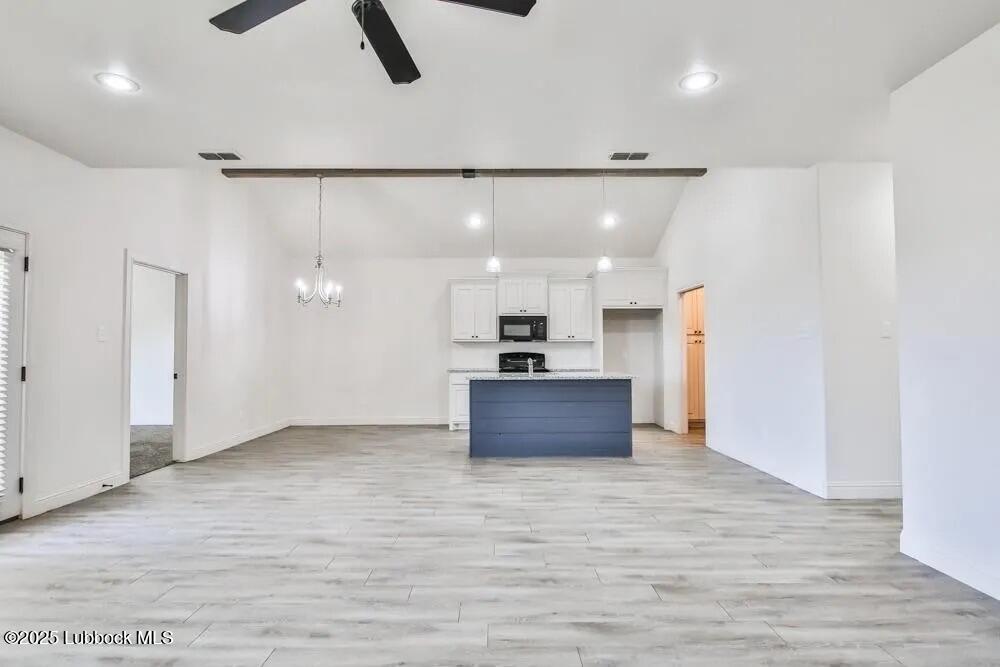 1602 102nd Street Lubbock, TX 79423 - Photo 3 of 16 a view of kitchen and kitchen with furniture wooden floor and window