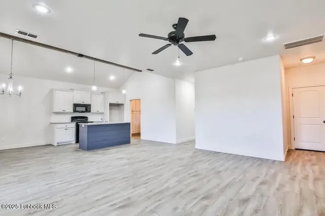 a view of kitchen with sink microwave and refrigerator