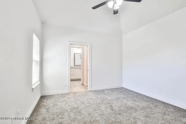 an empty room with a chandelier fan