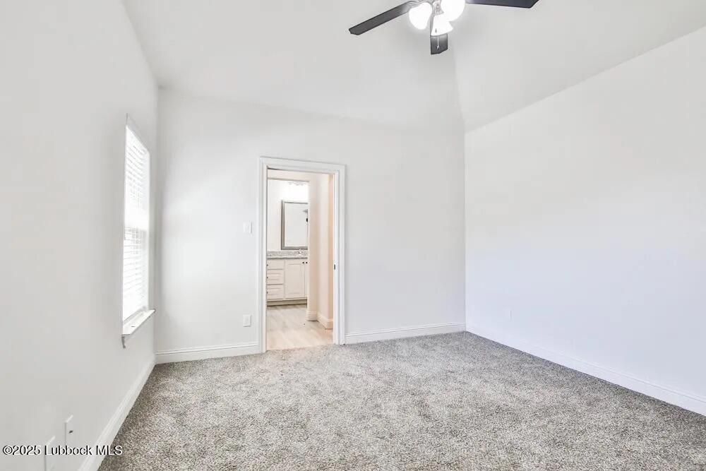 1602 102nd Street Lubbock, TX 79423 - Photo 6 of 16 an empty room with a chandelier fan