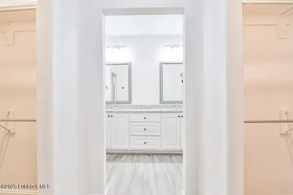 a bathroom with a sink vanity and a mirror