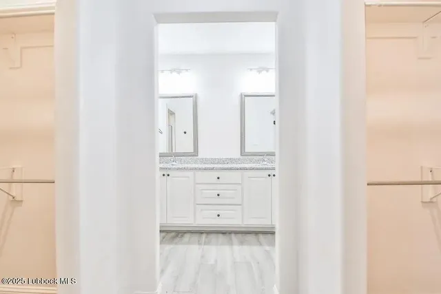 a bathroom with a sink vanity and a mirror