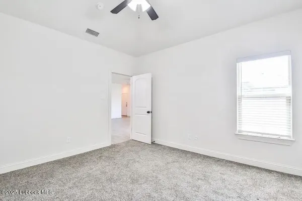 an empty room with a empty space and a ceiling fan