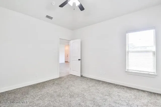 an empty room with a empty space and a ceiling fan