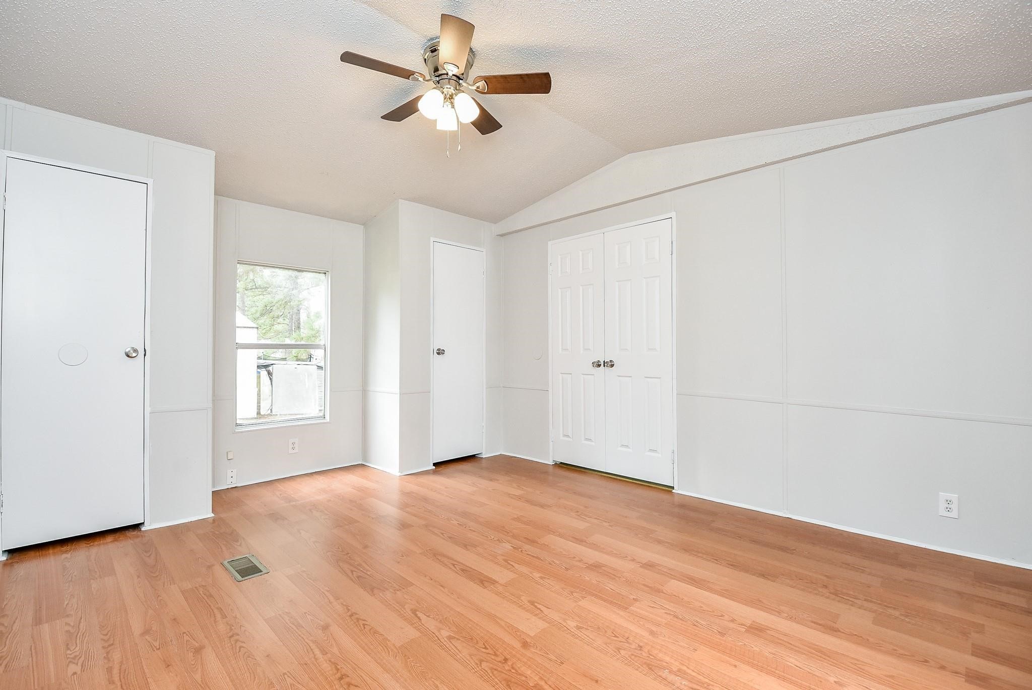 12842 Roy Harris Loop Conroe, TX 77306 - Photo 26 of 36 a view of empty room with wooden floor
