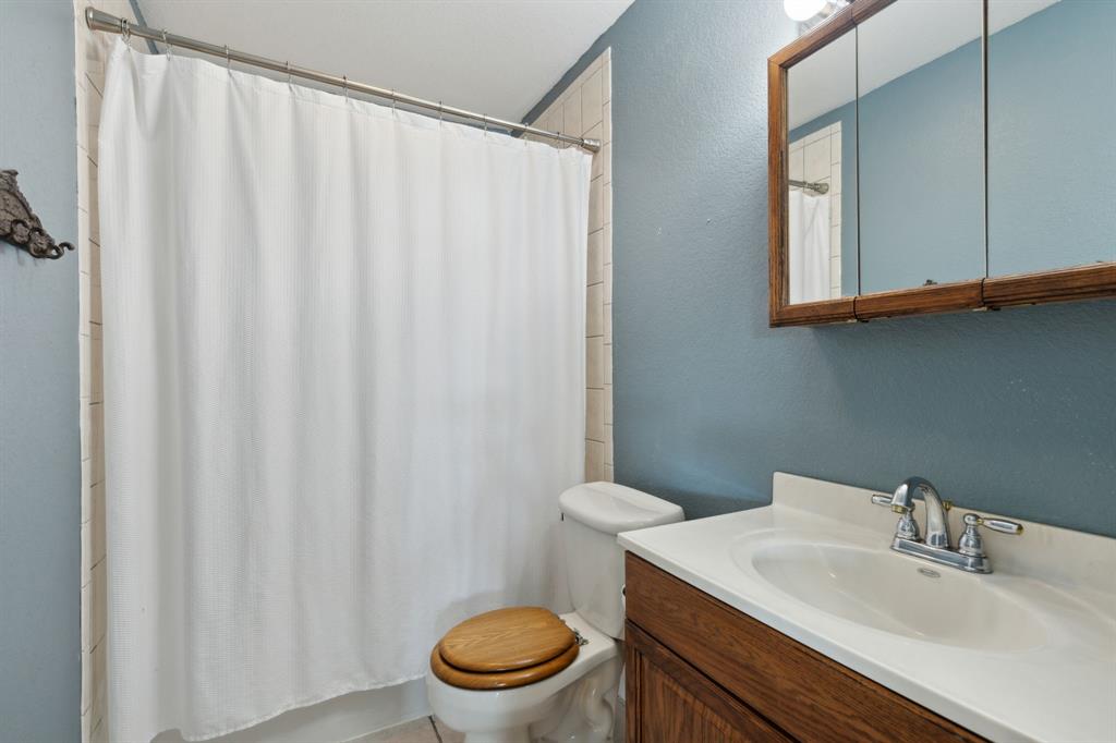 1133 VZ County Road Canton, TX 75103 - Photo 14 of 38 a bathroom with a sink a toilet and shower curtain