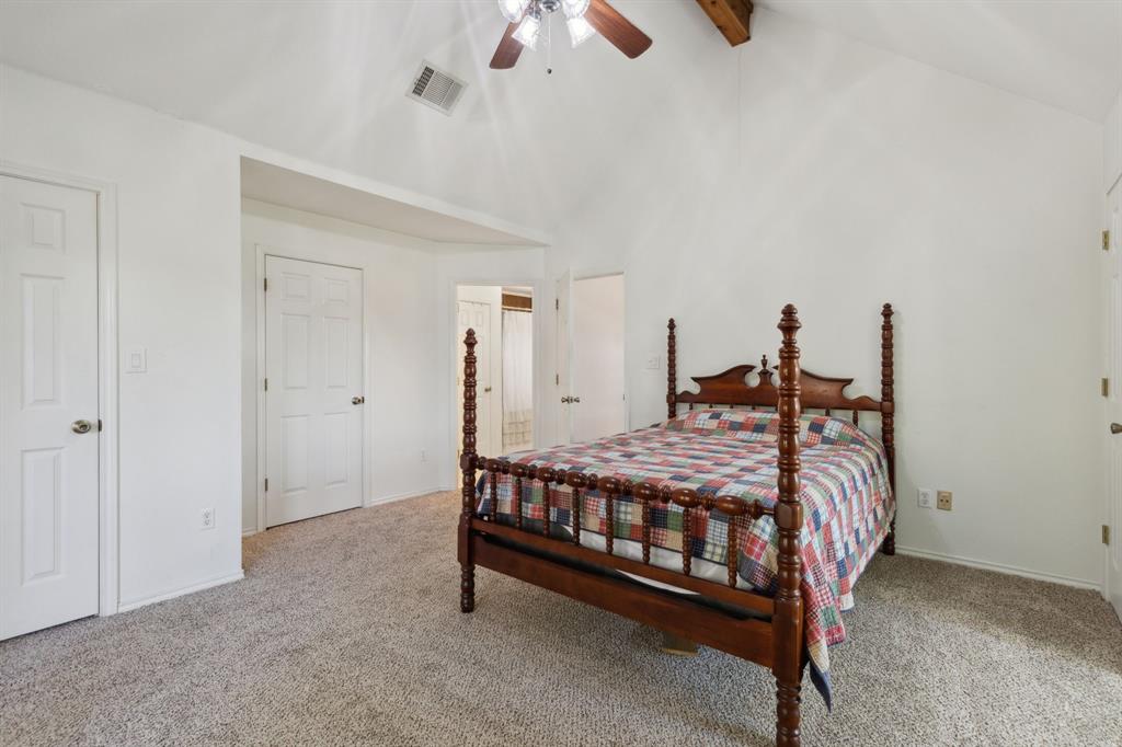 1133 VZ County Road Canton, TX 75103 - Photo 17 of 38 a bed sitting in a room with a chandelier